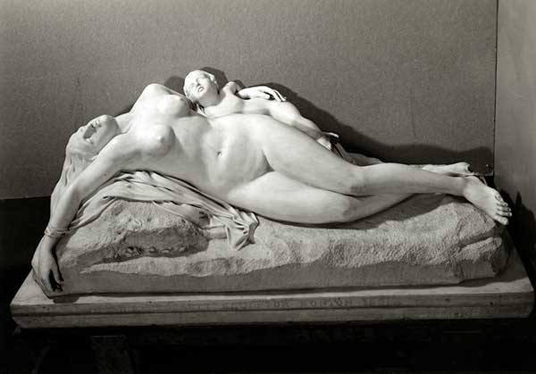 A nude mother cradling her young child, both with eyes closed and torsos twisted