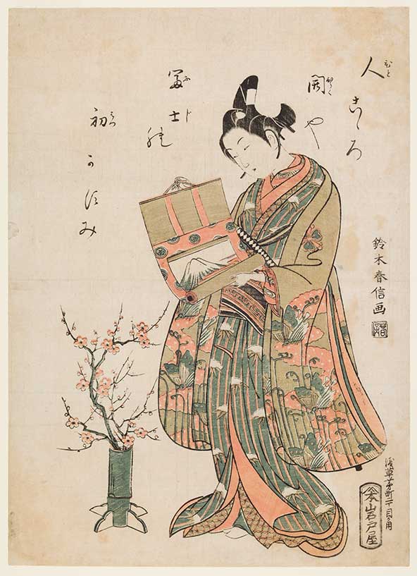 Suzuki Harunobu (1725–70), Youth (wakashu) Unrolling a Hanging Scroll, 1765–70, color woodblock print in red and green (benizuri-e)