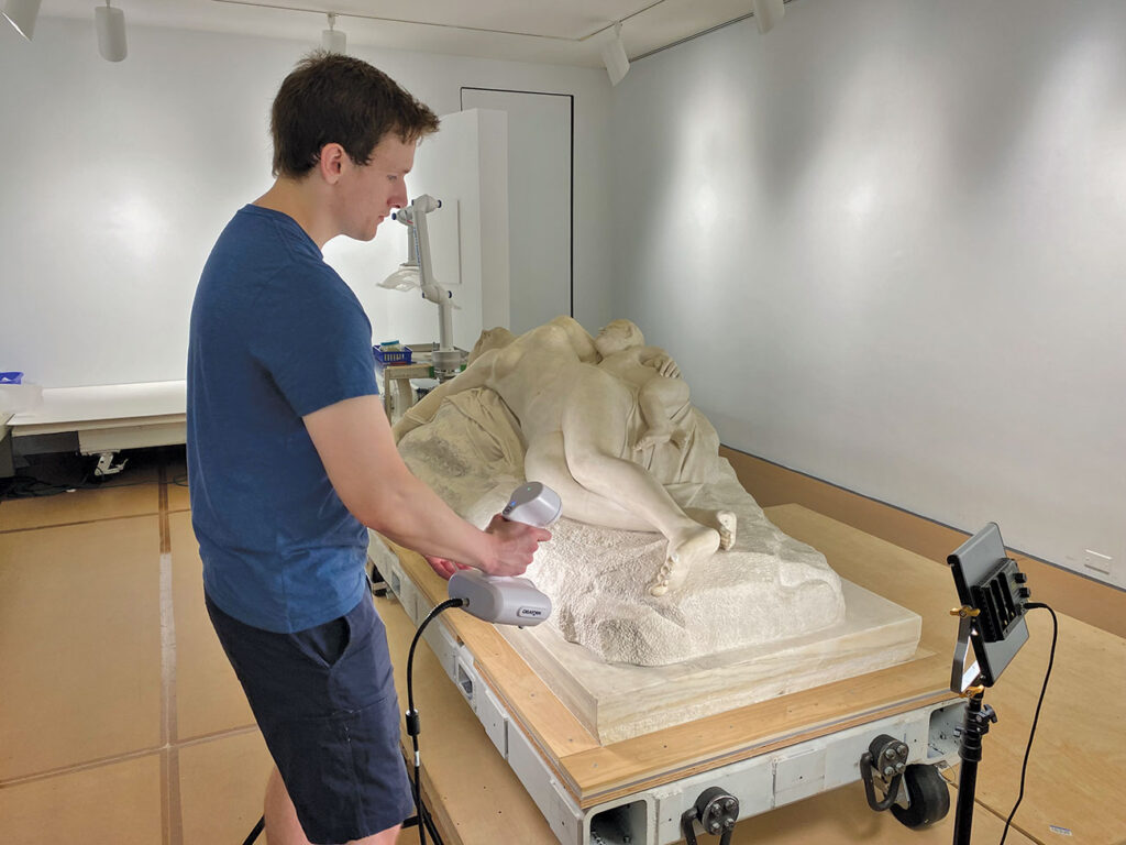 Colin Hiscox scanning 'Shipwrecked Mother and Child' sculpture