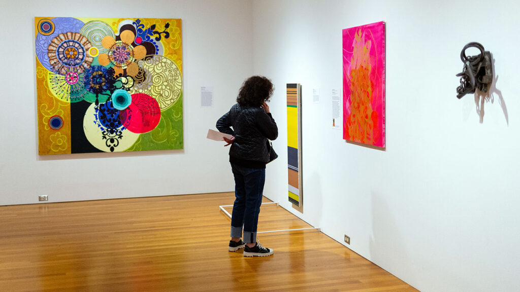 A visitor viewing contemporary artworks