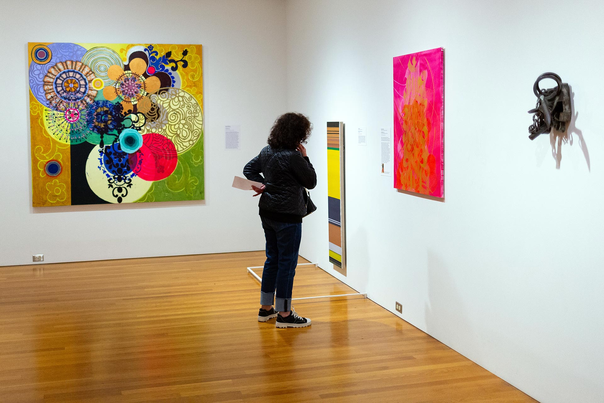 A visitor viewing contemporary artworks