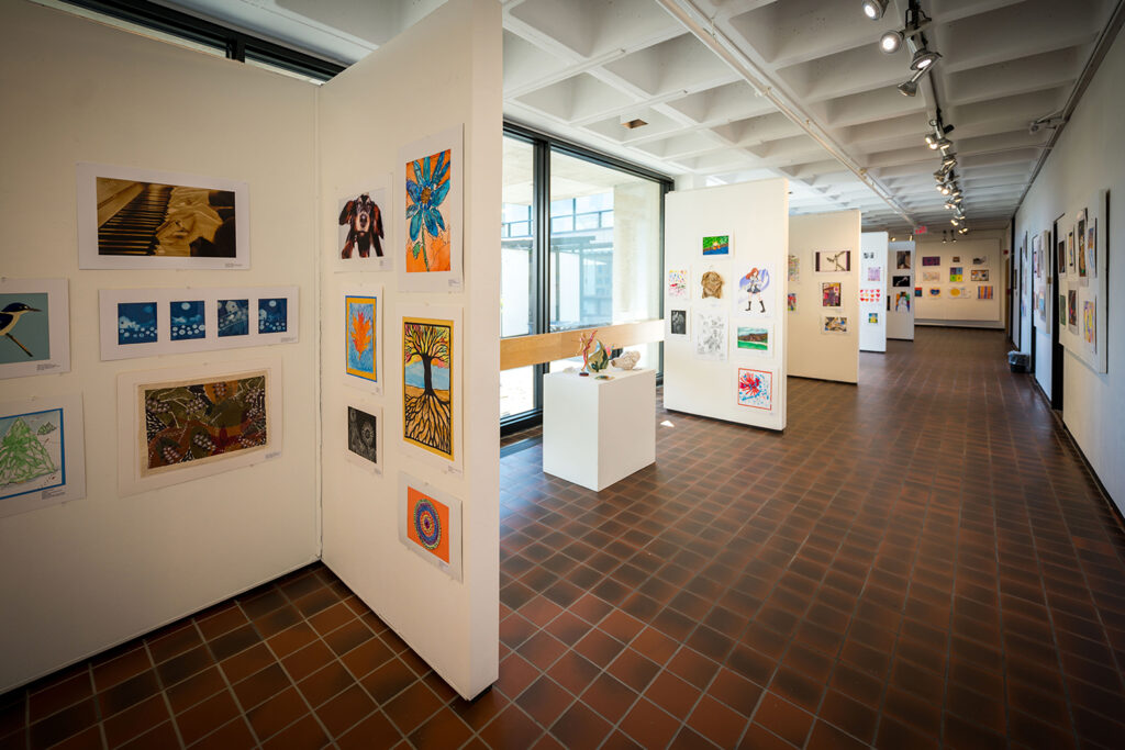 A view of an art exhibition in the Higgins Education Wing