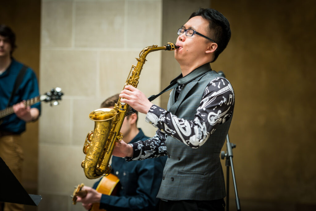A saxophonist playing during a performance by the Holy Cross Jazz Quartet