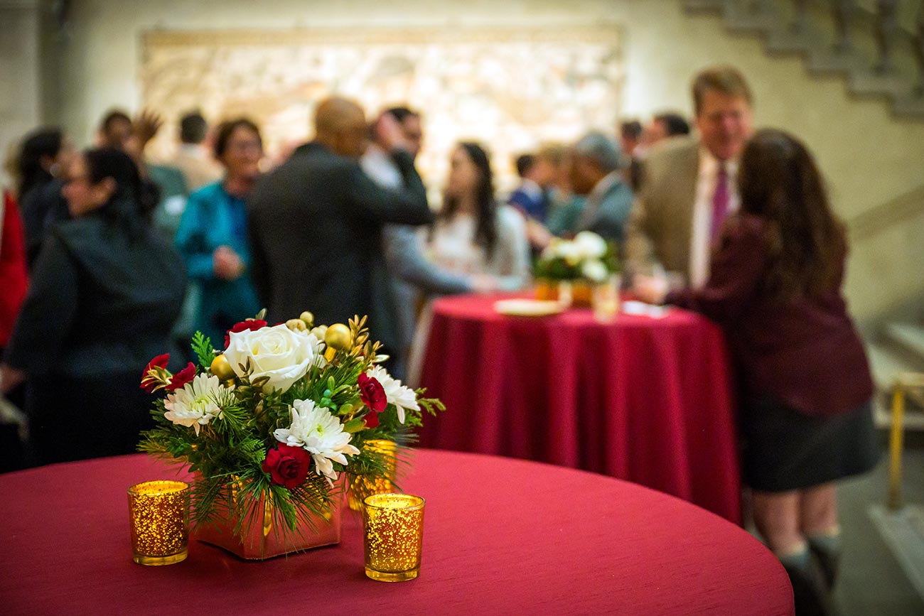 Tables decorated for the holidays in Renaissance Court and in the background guests gathered during an event