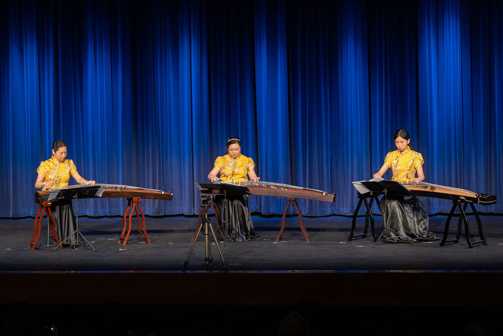 Boston Guzheng Ensemble Trio performing on stage