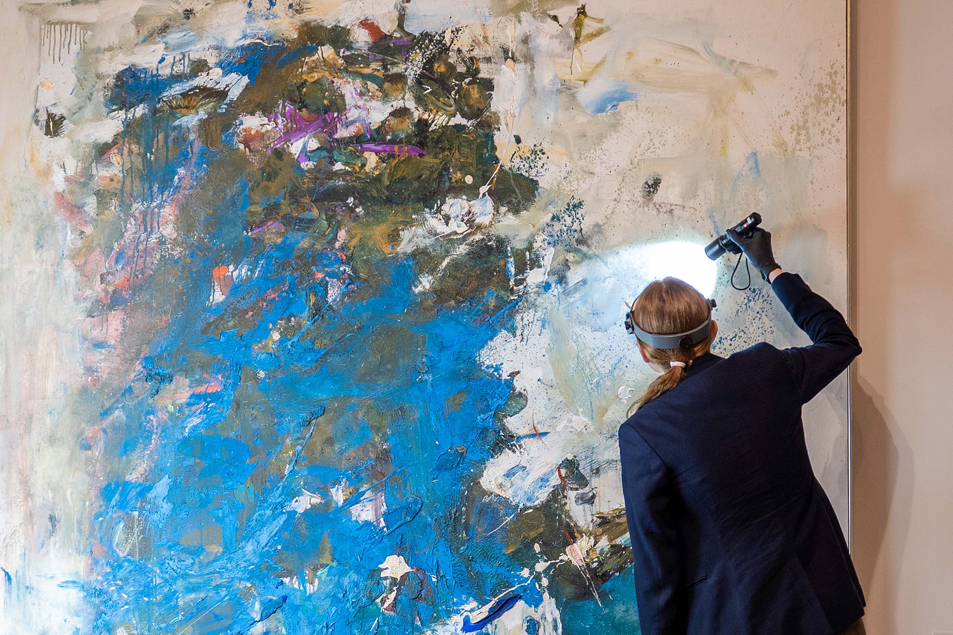 A conservator working on Joan Mitchell's painting 'Blue Tree'