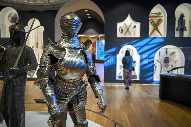 View of the Arms and Armor Galleries with a suit of armor in the foreground