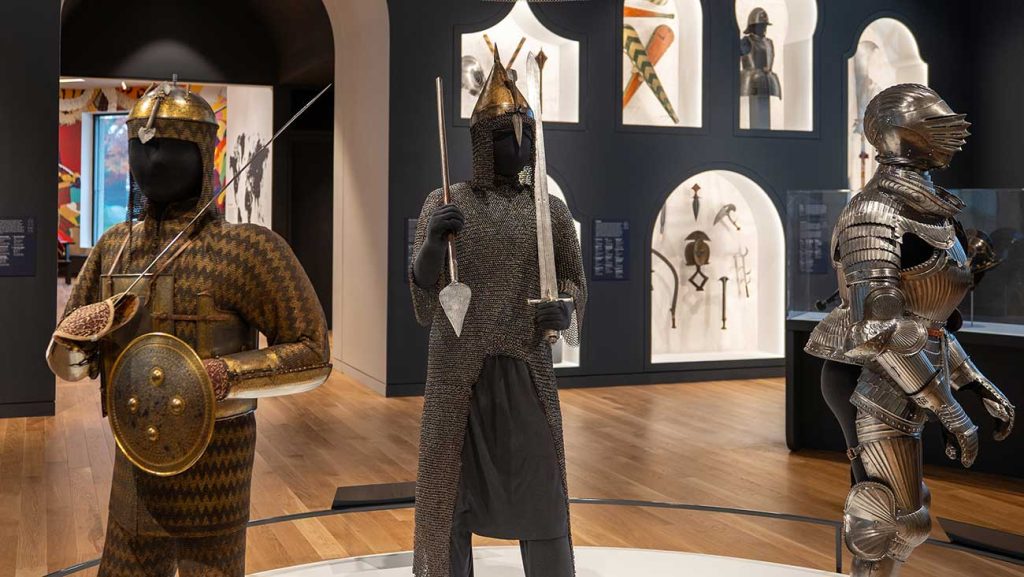 A view of the new Arms and Armor Galleries with three suits of armor displayed on mannequins in the foreground