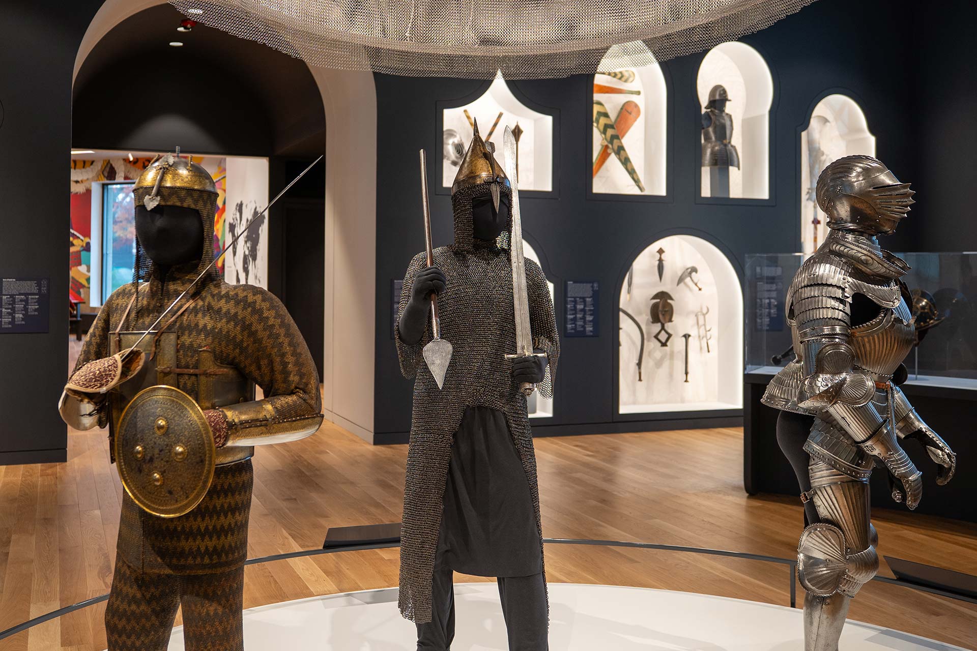 A view of the new Arms and Armor Galleries with three suits of armor displayed on mannequins in the foreground