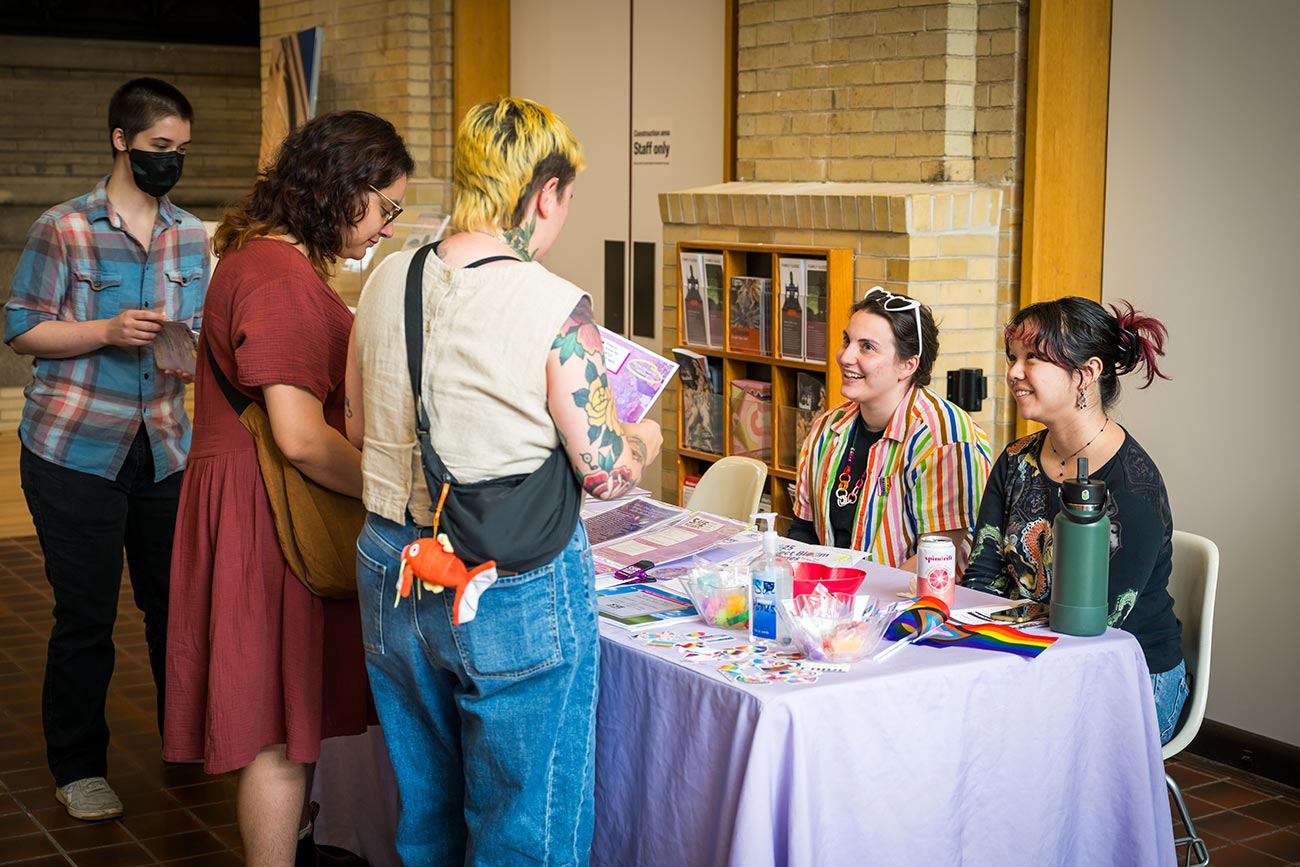 Visitors at a Pride community organization table