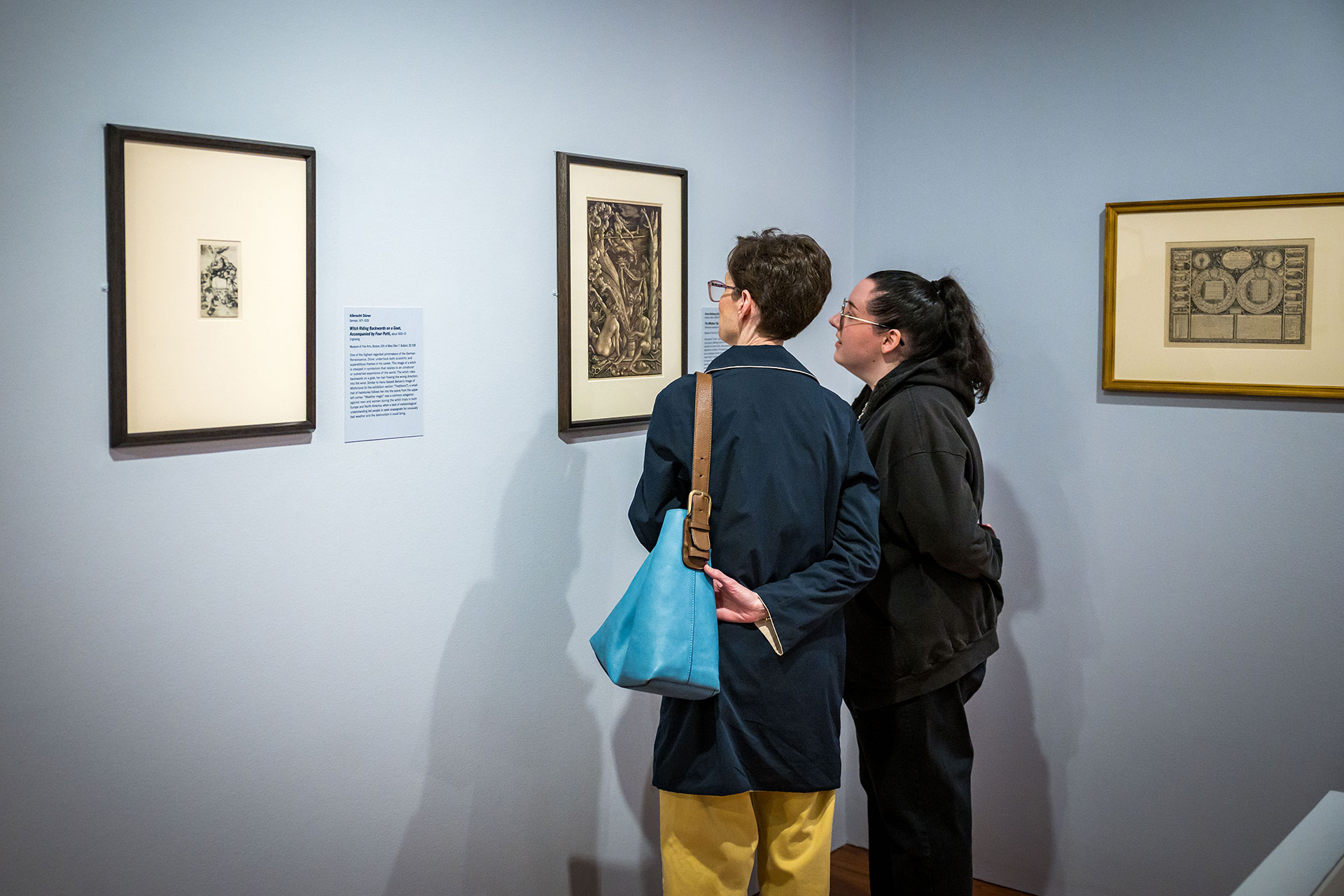 Two visitors viewing objects in the exhibition 'A Weather Eye: Art and Early Modern Meteorology'