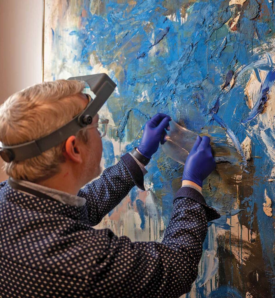 A conservator applies a specially formulated gel to the surface of 'Blue Tree' by Joan Mitchell.