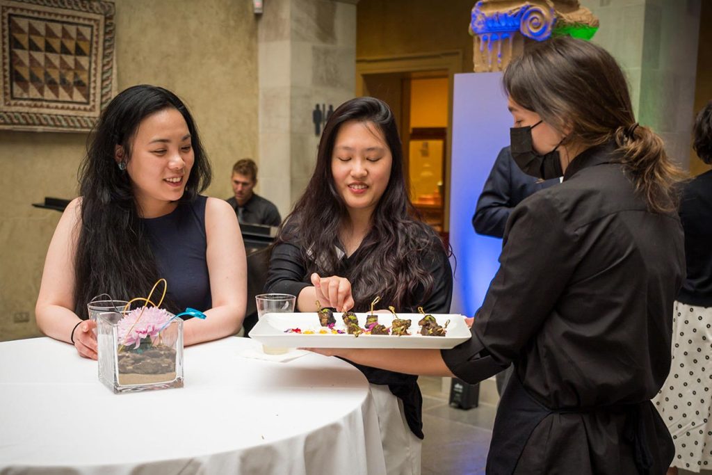 A server offers food to party guests
