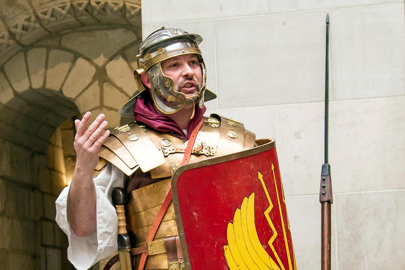 A Roman reenactor gestures as he speaks