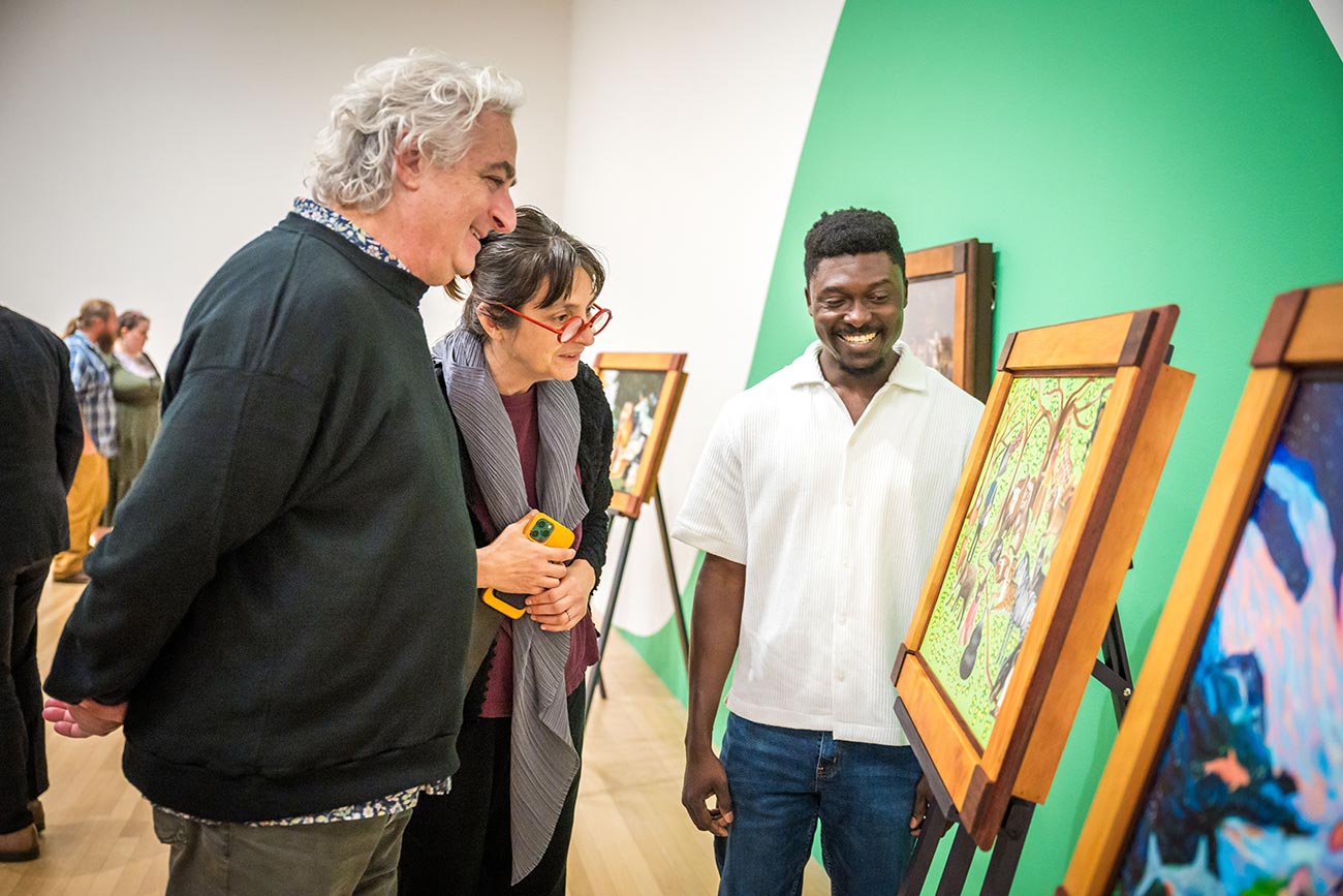 Artist Emmanuel Manu Opoku discusses his work with exhibition visitors