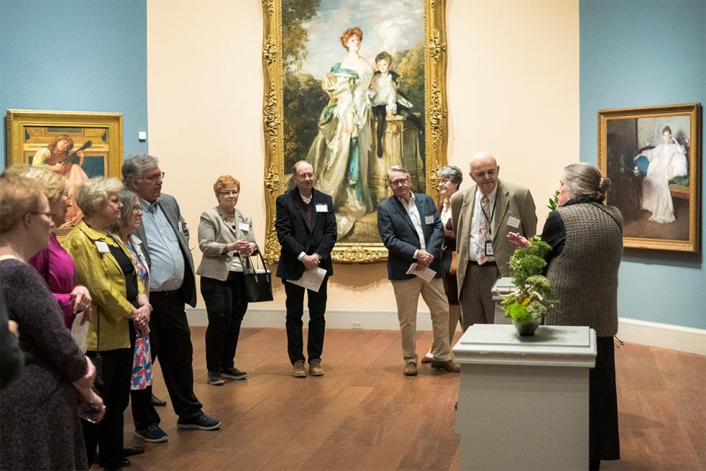 Salisbury Giving Society Members gather around a floral interpretation during a tour