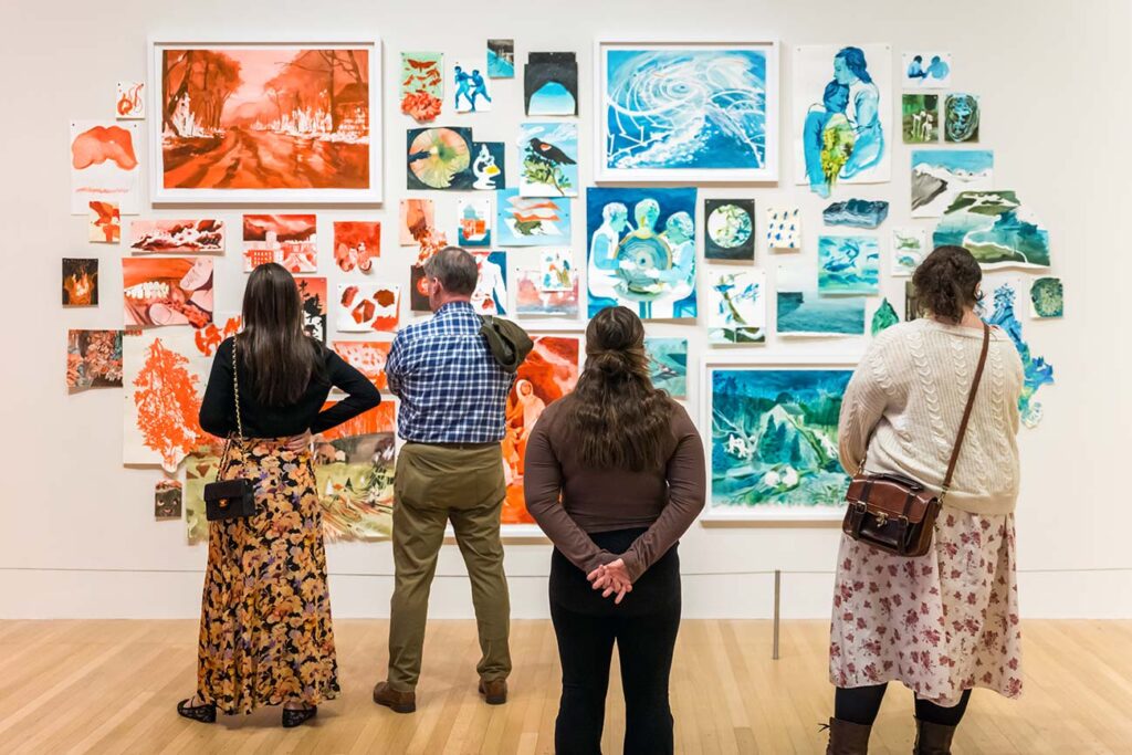 A group of visitors viewing the exhibition 'Fever Dreams of a Cool-Breathed Earth'