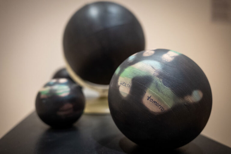 Andrew S. Yang and Christa Donner, 'In(Visible) Heat,' wood and cardboard globes with ink and thermochromic paint, 2025, dimensions variable.