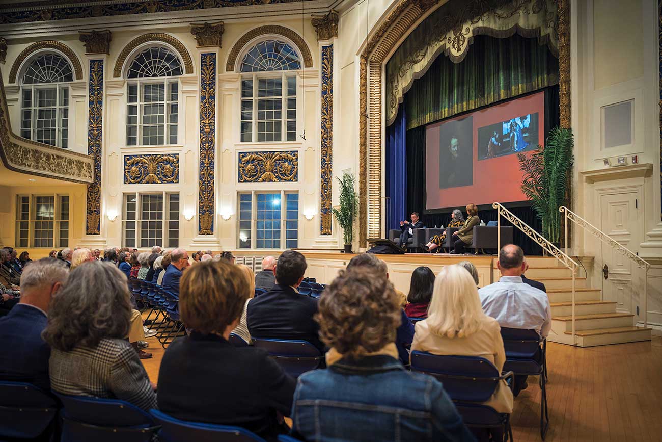 Interior view of Tuckerman Hall with a talk in progress on stage