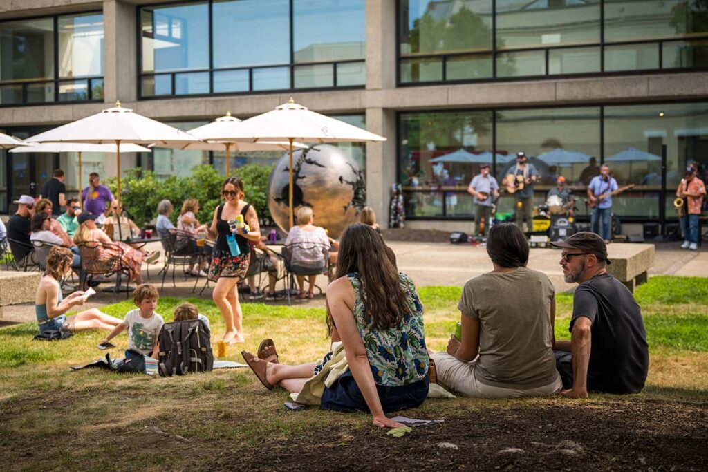 A visitors enjoy a summer event in Stoddard Garden Courtyard