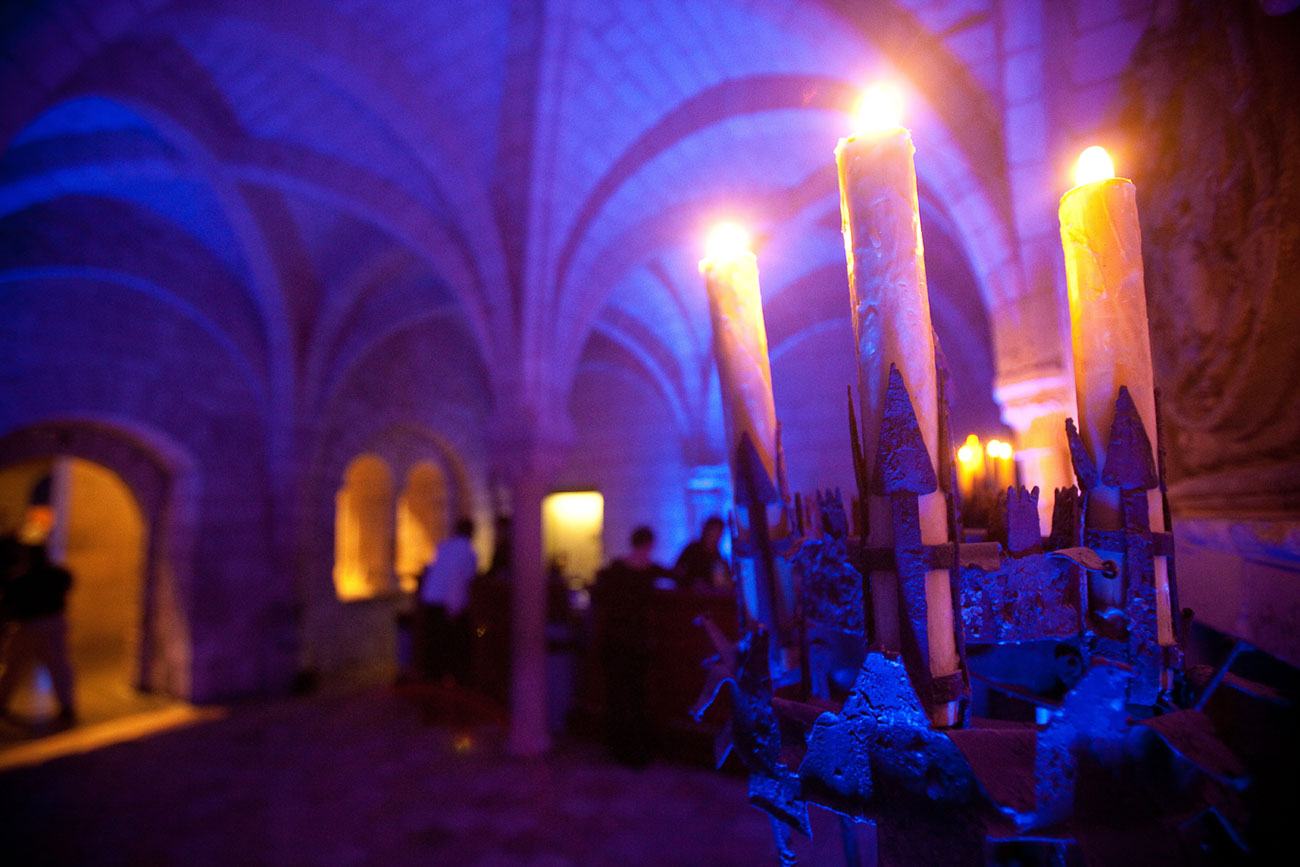 Candles illuminate the Chapter House during an event
