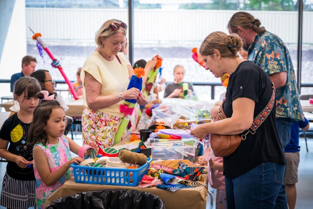 Youth and adults choose materials for their artmaking